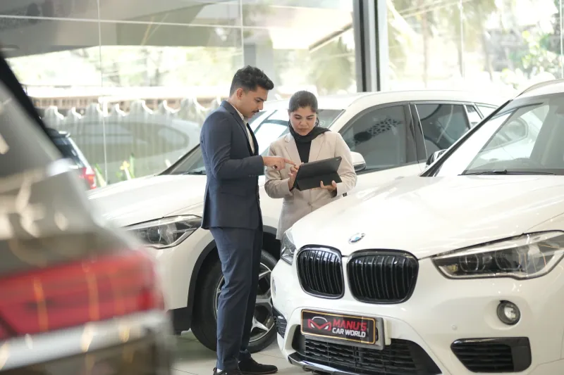 The owner and staff of Manu's Car World together at the showroom